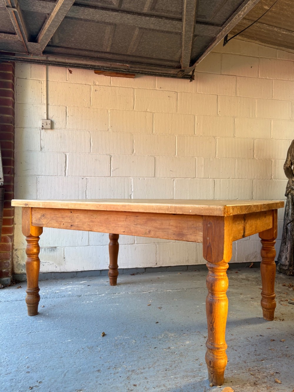 An Edwardian rectangular pine farmhouse kitchen table featuring turned elm legs and a thick wooden top. View II