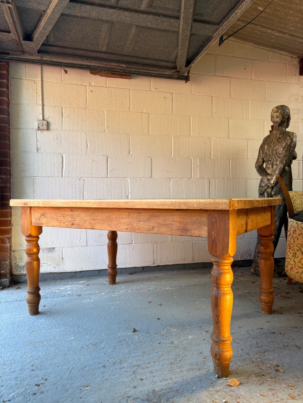 An Edwardian rectangular pine farmhouse kitchen table featuring turned elm legs and a thick wooden top. View IX