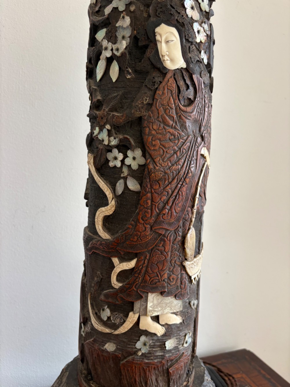 A tall Japanese Meiji period carved wooden brush pot converted into a table lamp with mother-of-pearl details and a patterned pleated lampshade. View V