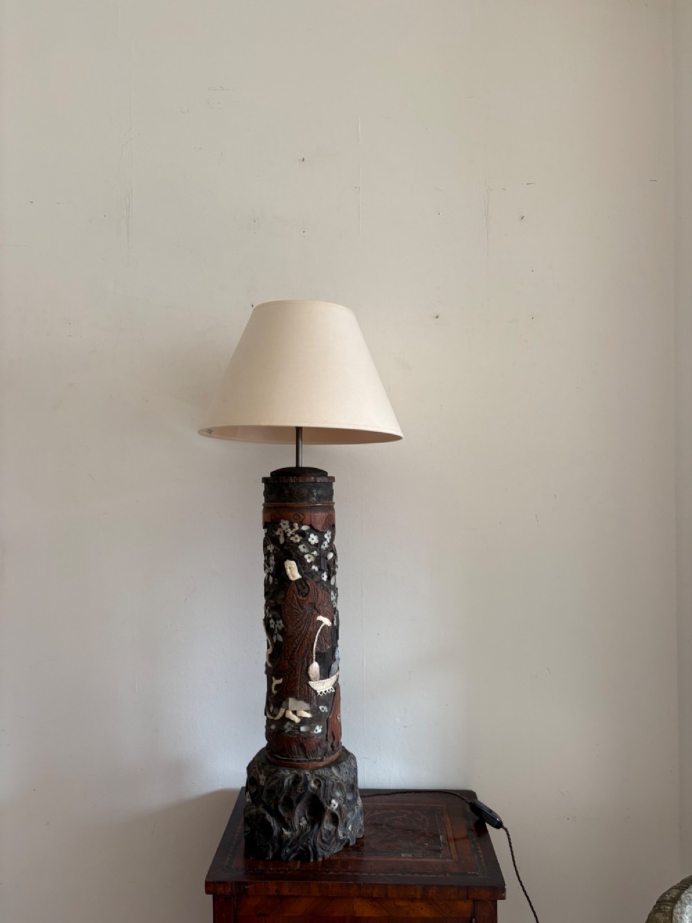 A tall Japanese Meiji period carved wooden brush pot converted into a table lamp with mother-of-pearl details and a patterned pleated lampshade. View X