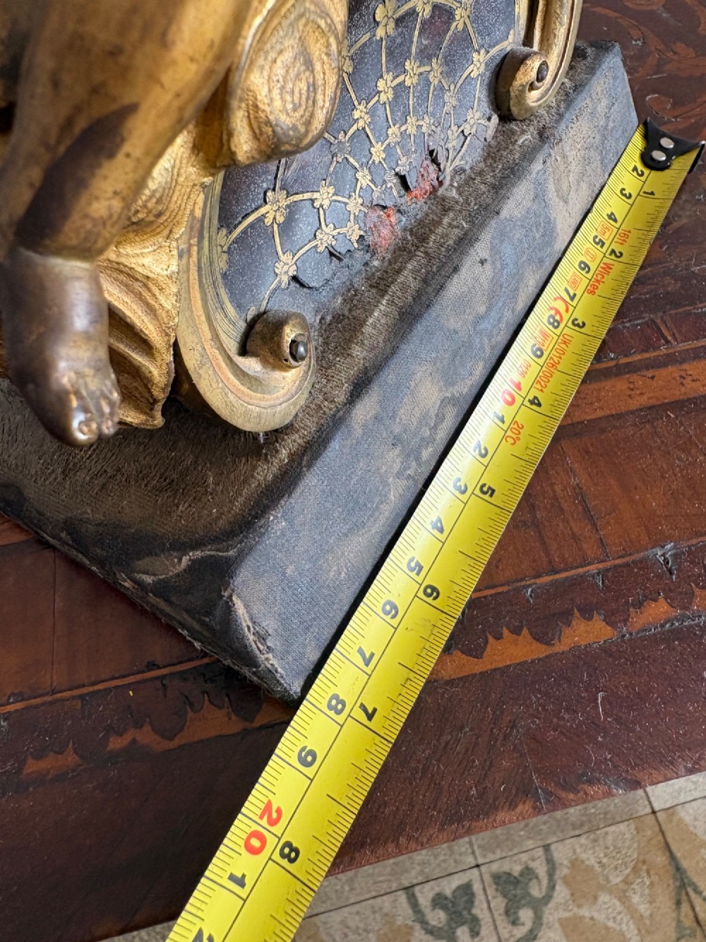 A late eighteenth or nineteenth-century French gilt bronze ormolu sculpture featuring a reclining putto holding a small vessel above a scrolled arch base. View XV