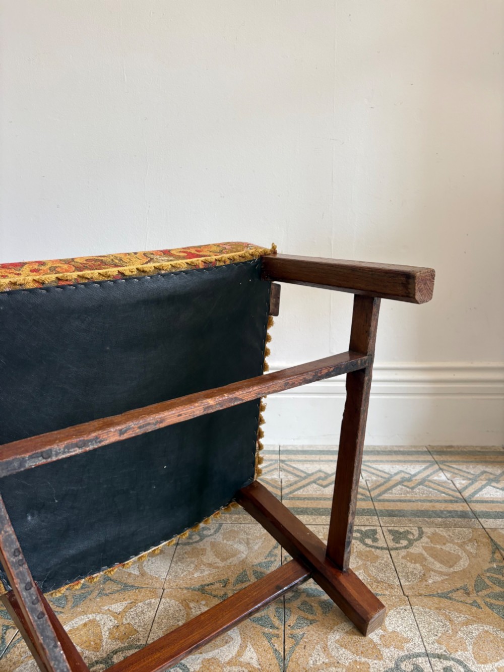 A George III elm ladderback open armchair featuring scrolled armrests and a patterned upholstered seat with fringed trim. View IX