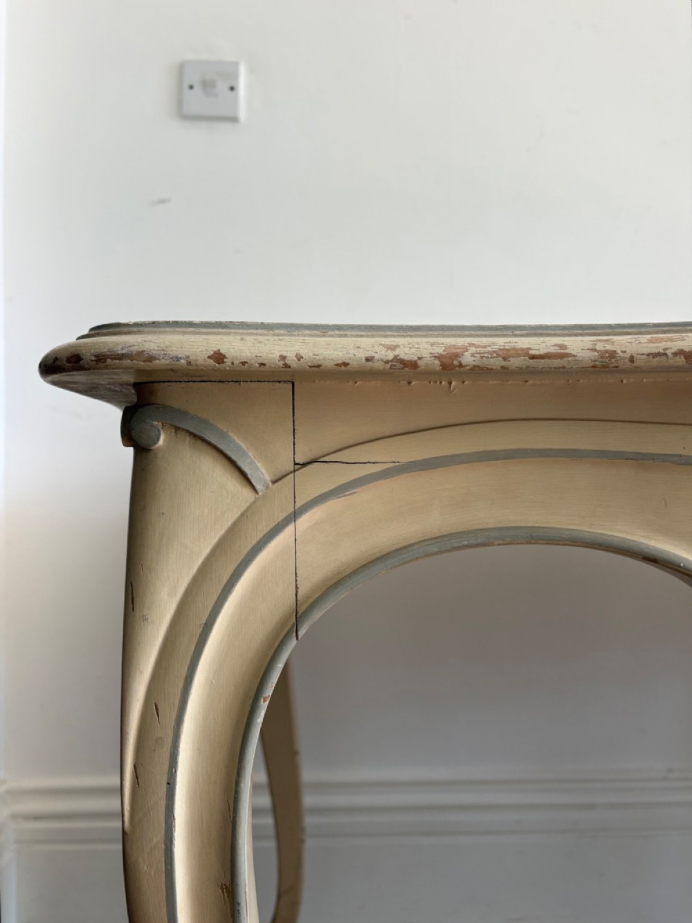 A cream painted French console table featuring long cabriole legs, a shaped apron with subtle trim, and an inset suede tabletop. View II