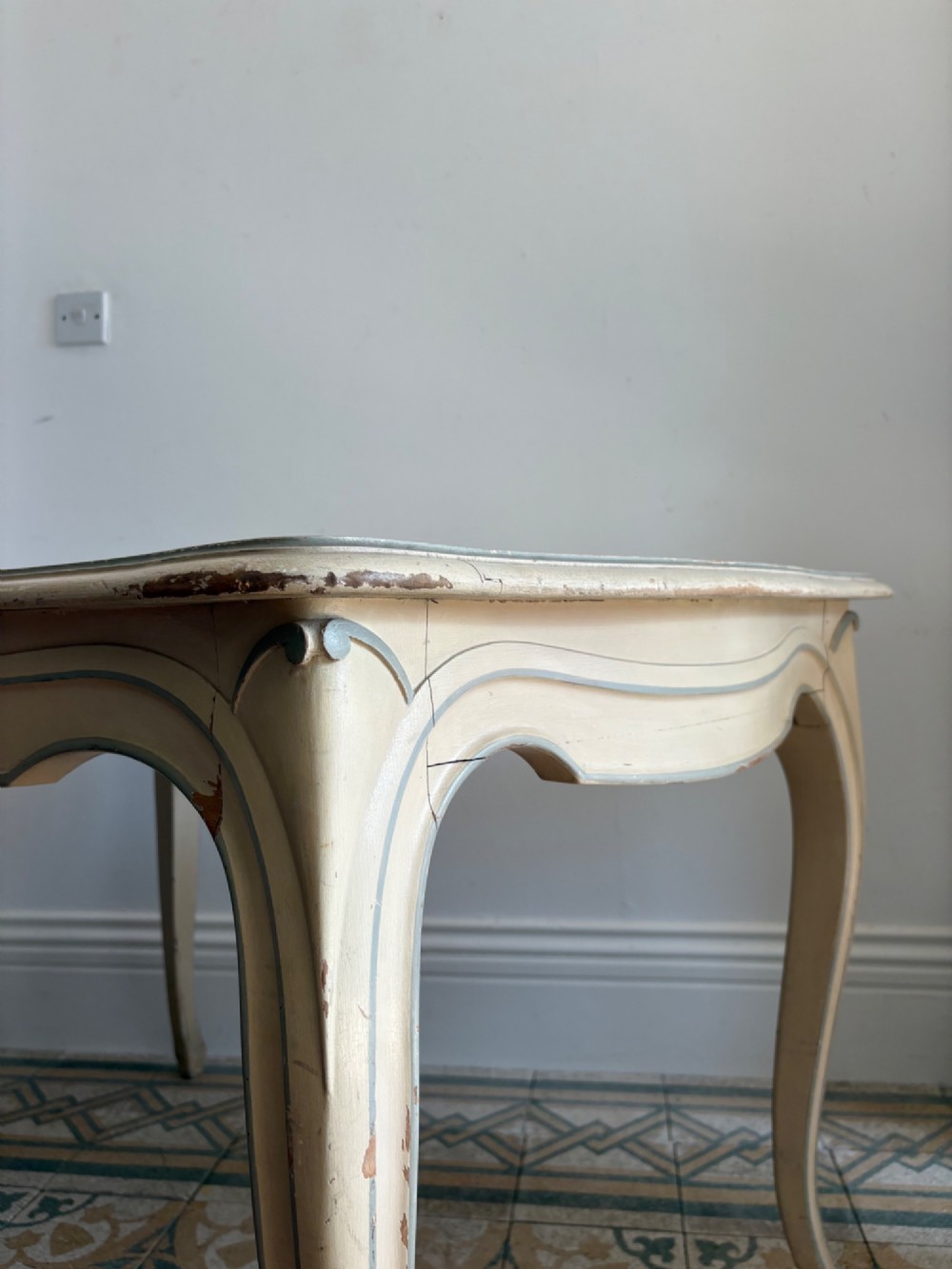 A cream painted French console table featuring long cabriole legs, a shaped apron with subtle trim, and an inset suede tabletop. View IV