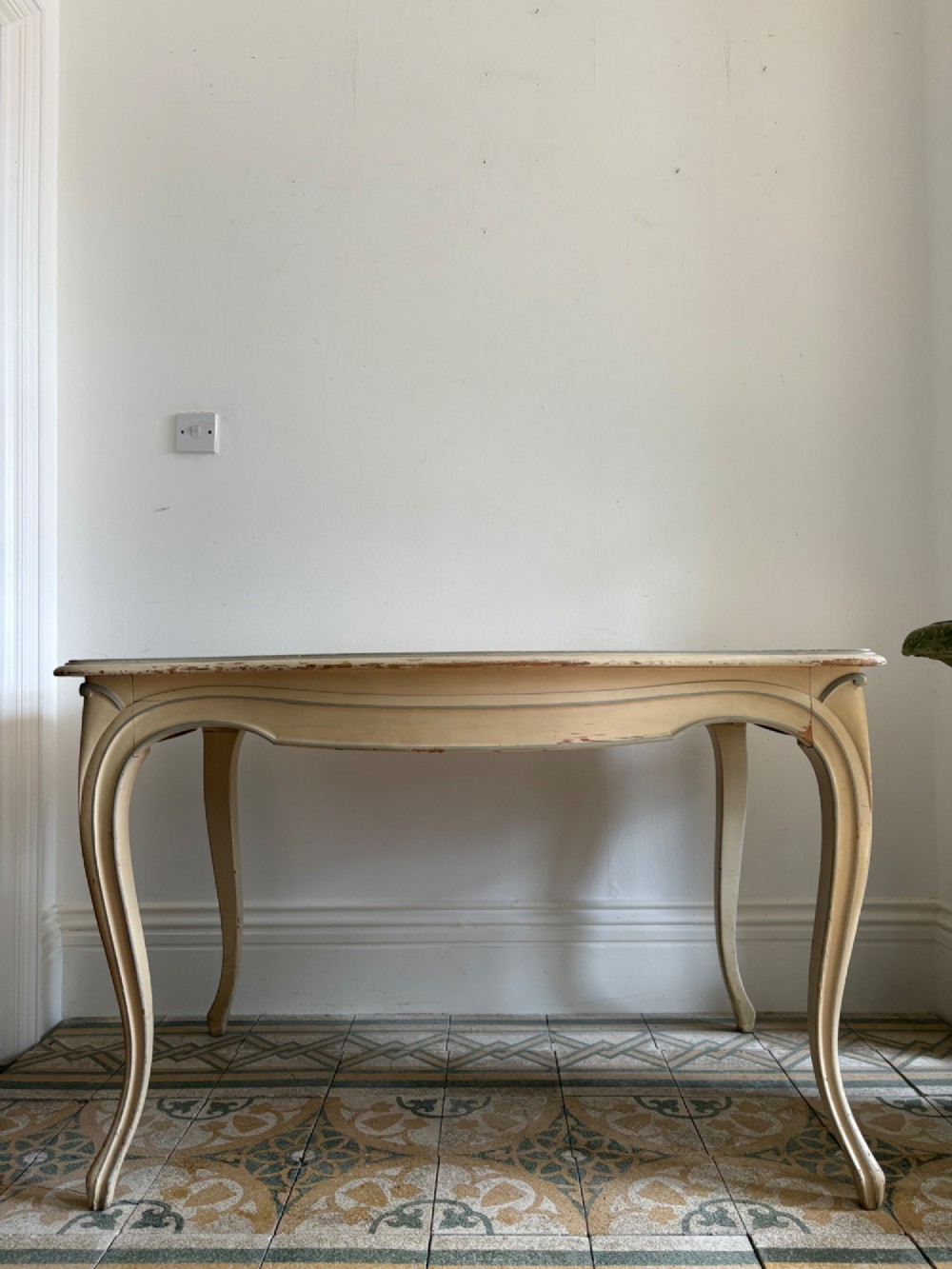 A cream painted French console table featuring long cabriole legs, a shaped apron with subtle trim, and an inset suede tabletop. View IX