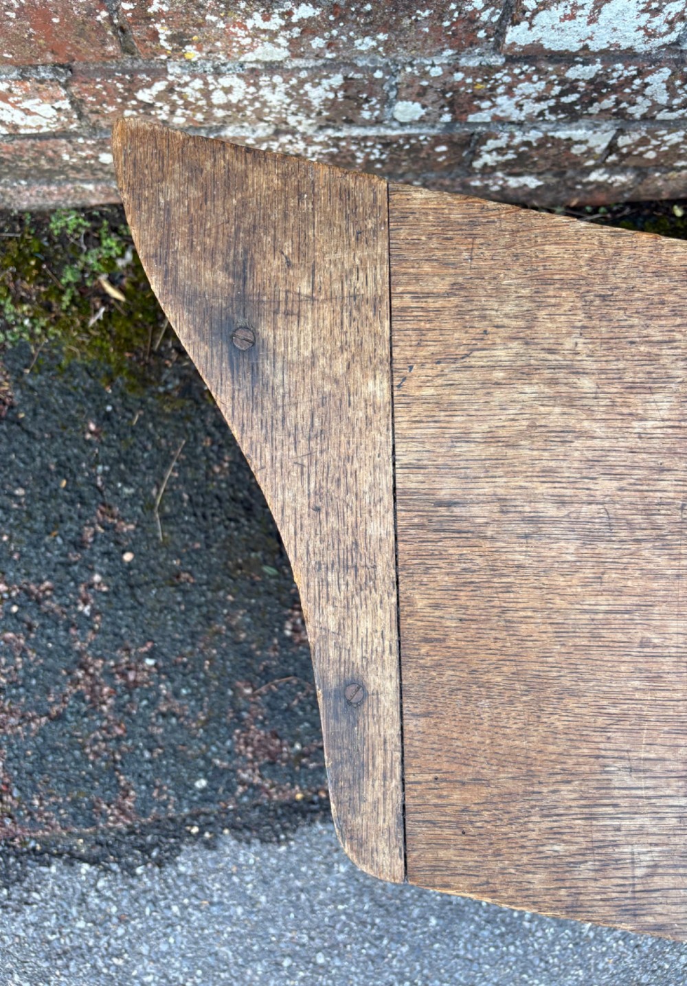 A long curved oak bench featuring trefoil carved cut-outs on the end supports. View VIII