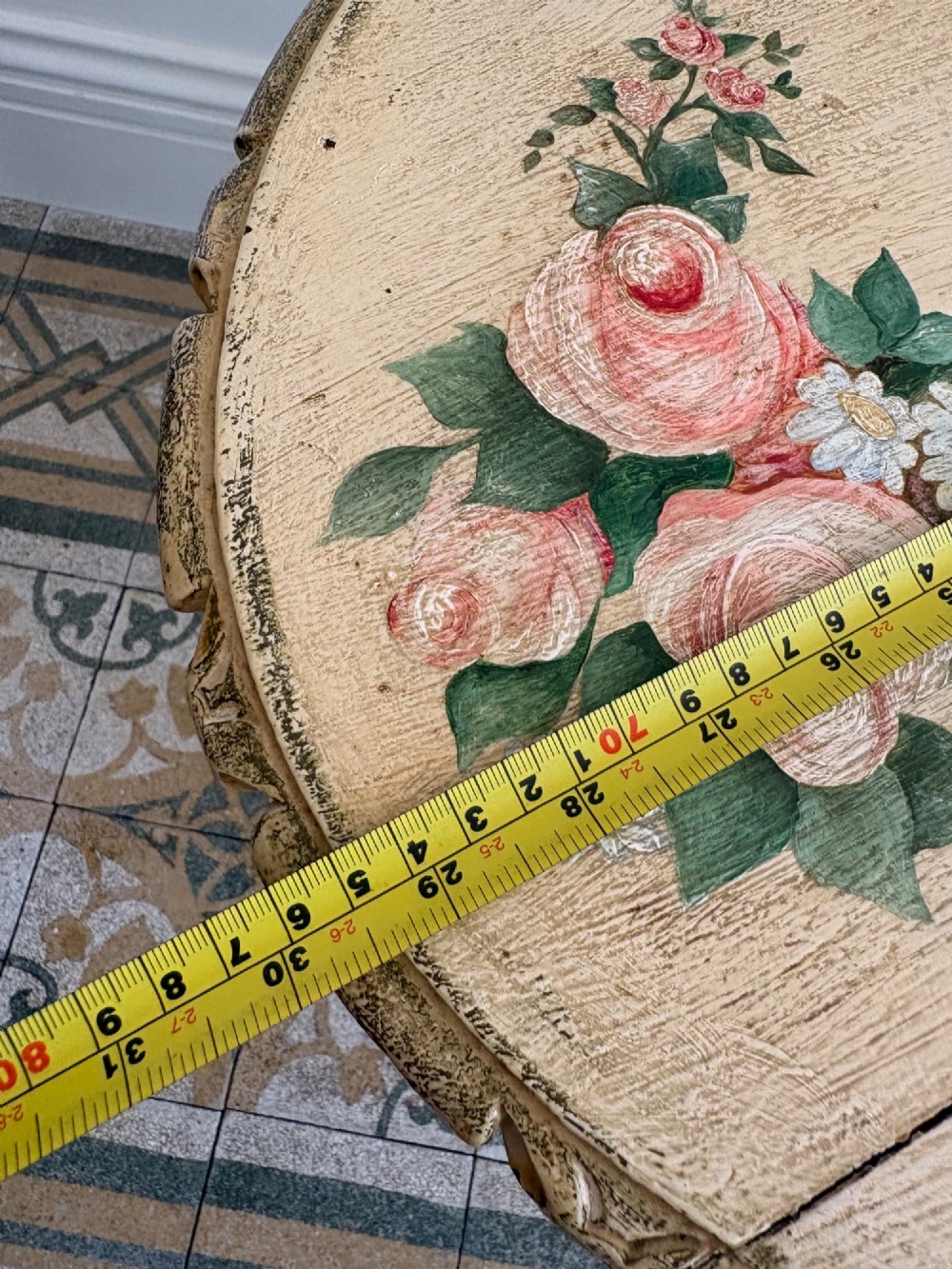 An oval cream-painted mahogany occasional table with hand-painted floral garlands, fluted apron, and square tapered fluted legs. View XIV