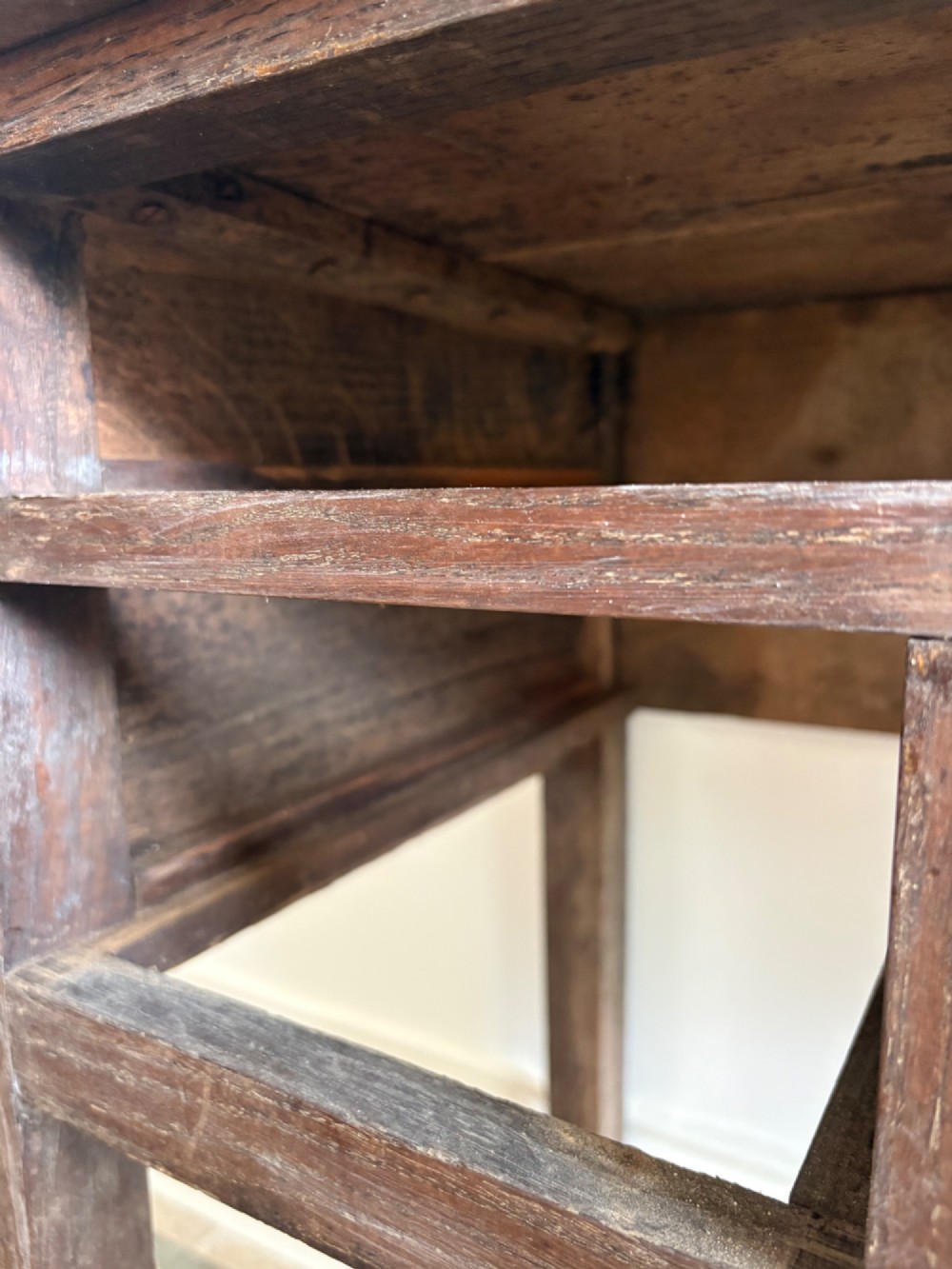 An early eighteenth-century oak lowboy side table featuring one wide upper drawer, two small side drawers, an arched apron, brass handles, and straight square legs. View XI