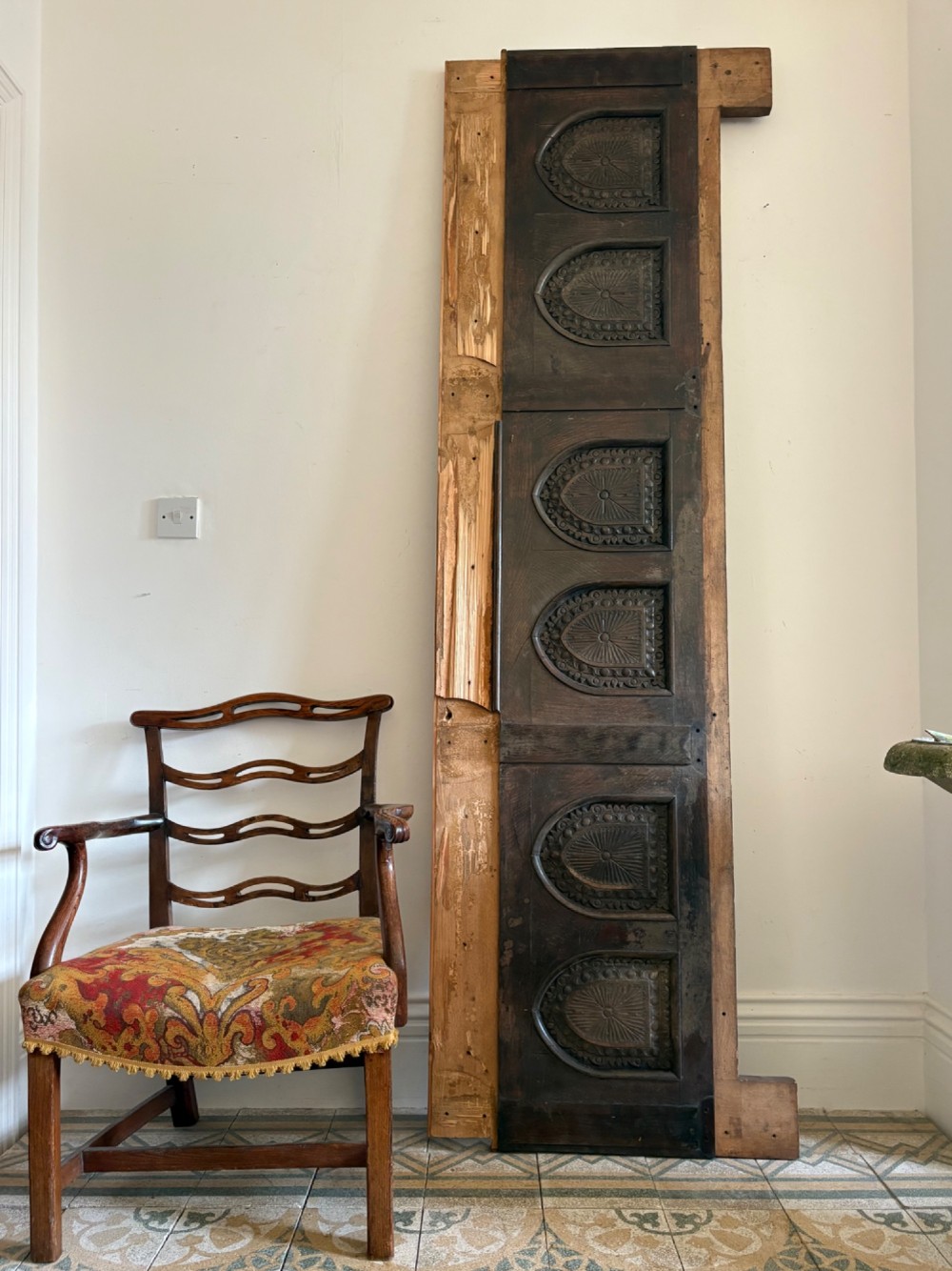 A tall nineteenth-century dark oak architectural panel featuring six vertically arranged carved gothic arches with fan motifs.