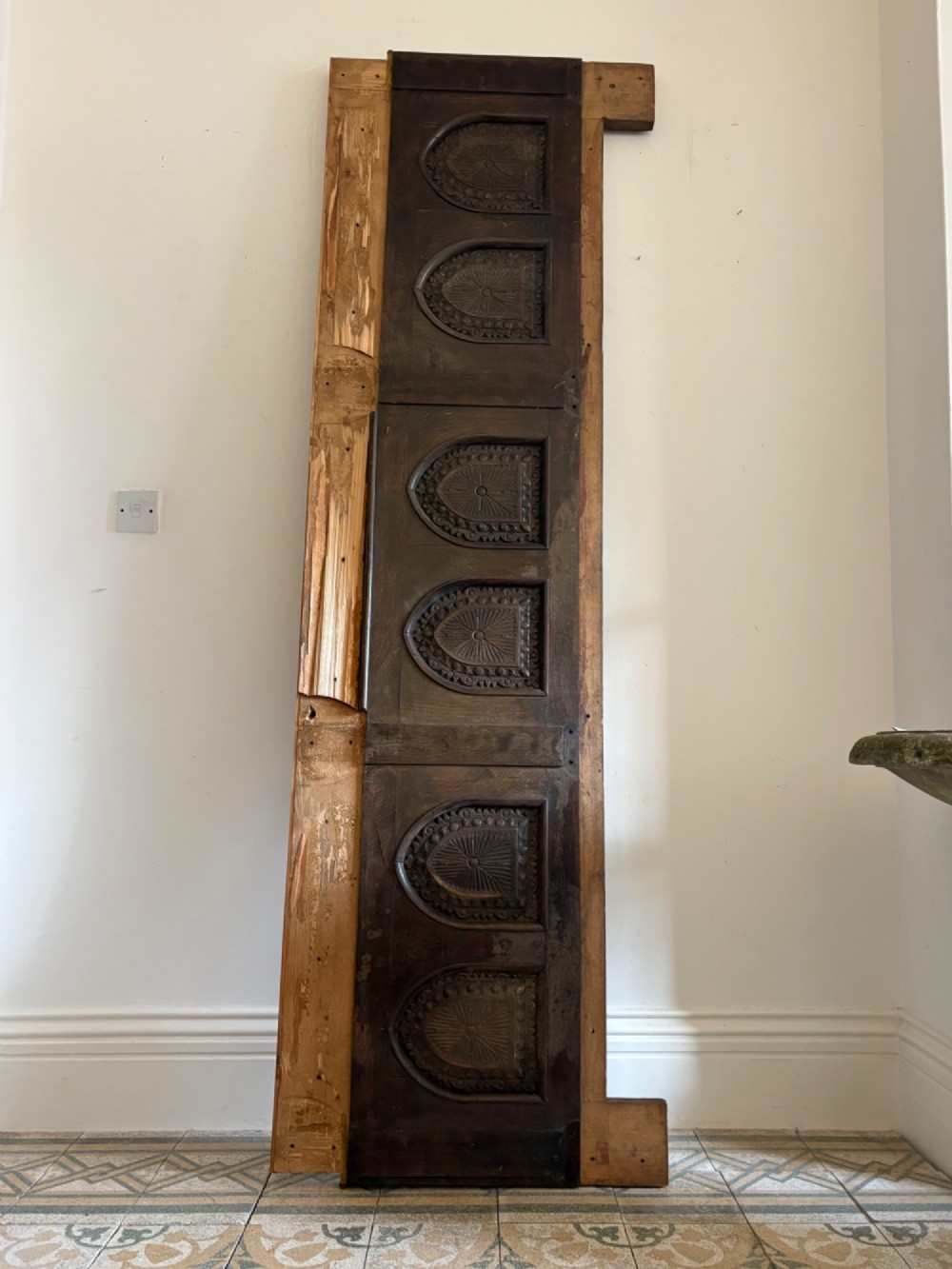 A tall nineteenth-century dark oak architectural panel featuring six vertically arranged carved gothic arches with fan motifs. View II