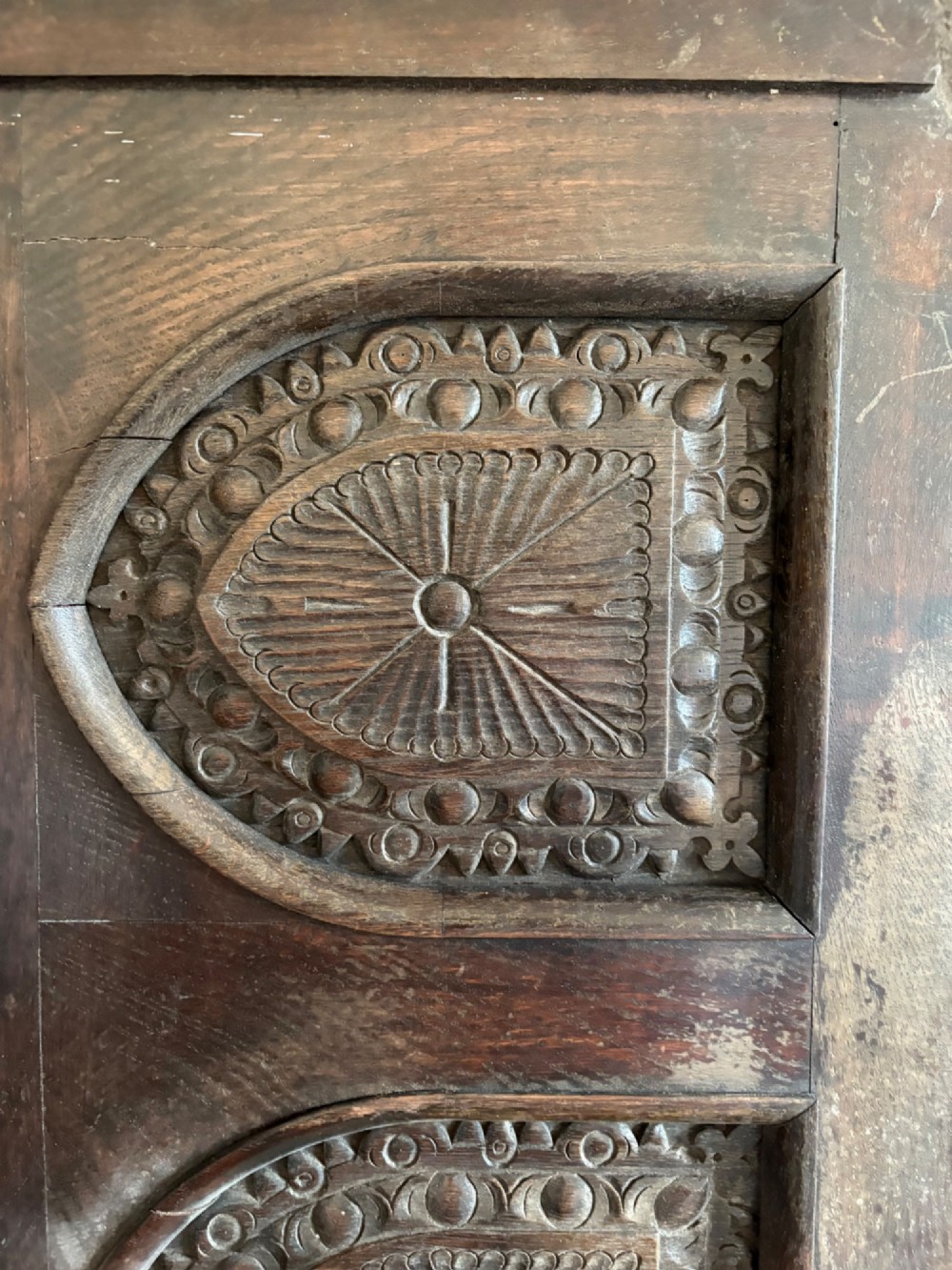 A tall nineteenth-century dark oak architectural panel featuring six vertically arranged carved gothic arches with fan motifs. View III