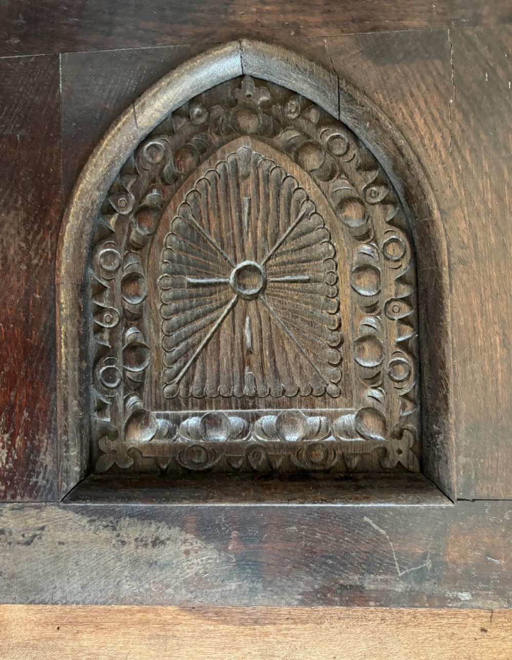 A tall nineteenth-century dark oak architectural panel featuring six vertically arranged carved gothic arches with fan motifs. View IV