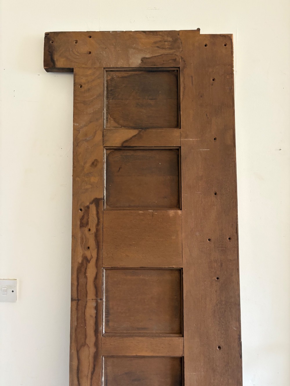 A tall nineteenth-century dark oak architectural panel featuring six vertically arranged carved gothic arches with fan motifs. View V