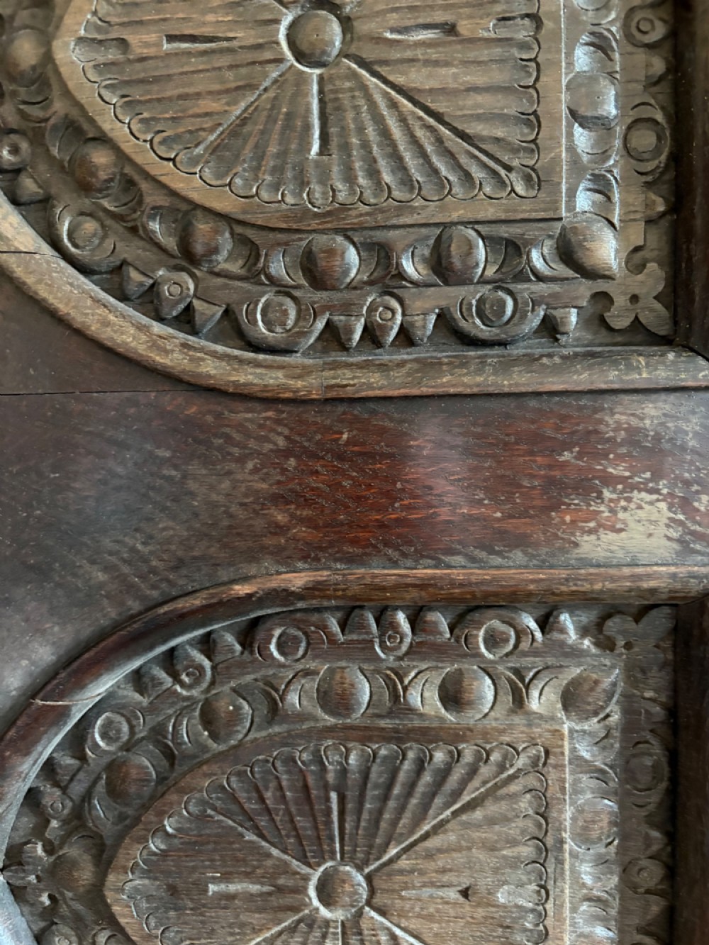 A tall nineteenth-century dark oak architectural panel featuring six vertically arranged carved gothic arches with fan motifs. View XII