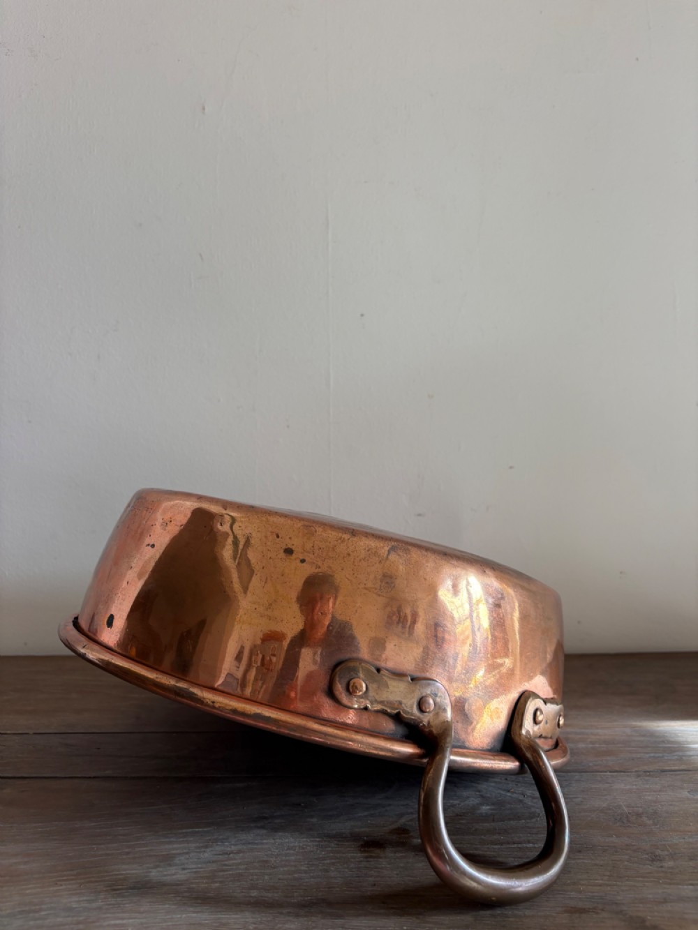 A large 19th-century polished copper preserve pan featuring twin riveted brass handles. View VII