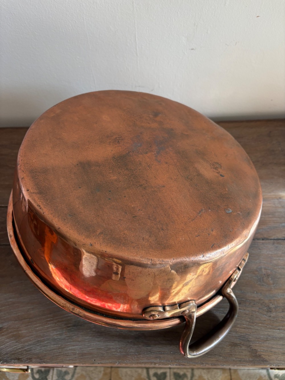 A large 19th-century polished copper preserve pan featuring twin riveted brass handles. View VIII