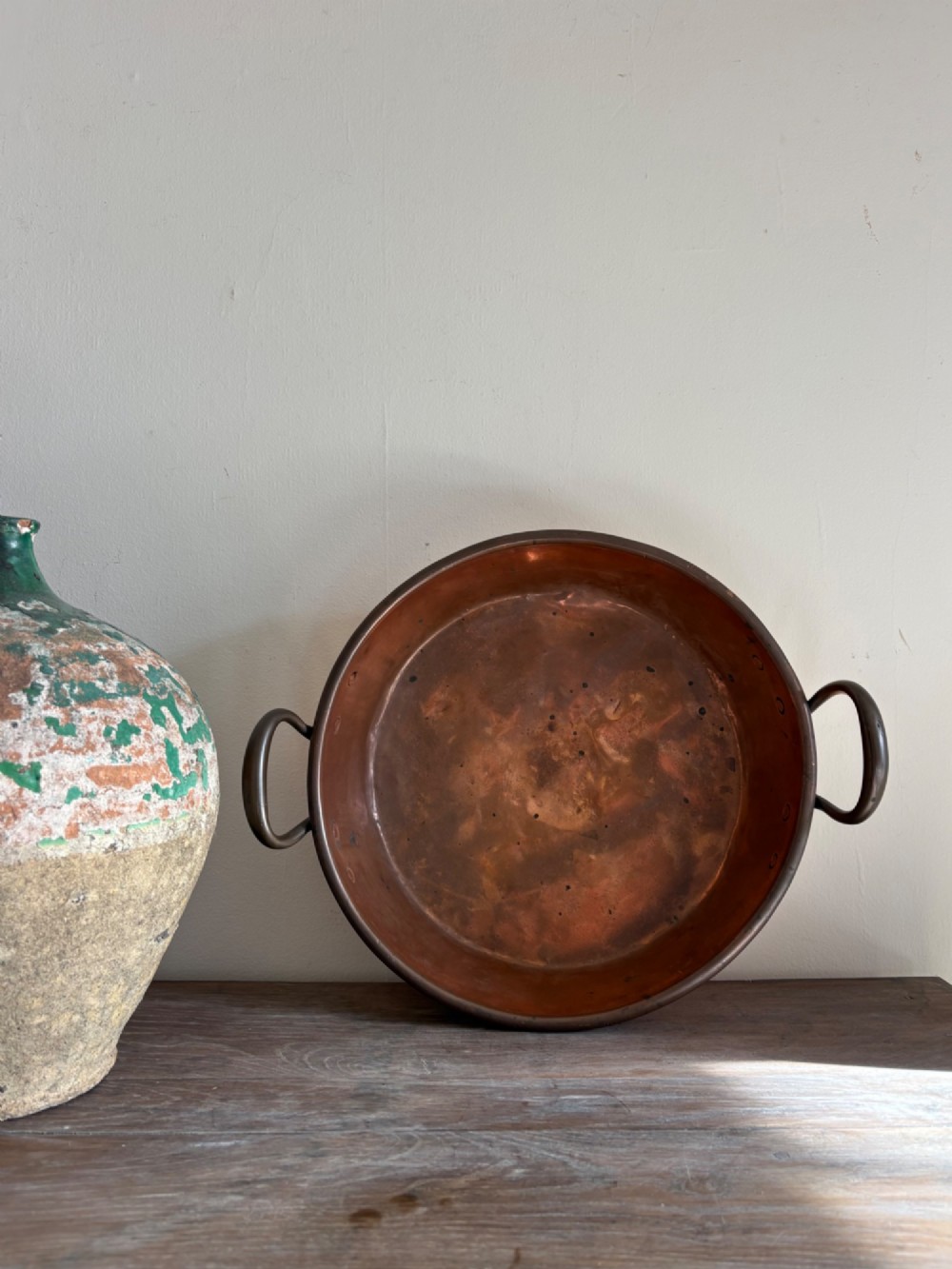 A large 19th-century polished copper preserve pan featuring twin riveted brass handles. View X