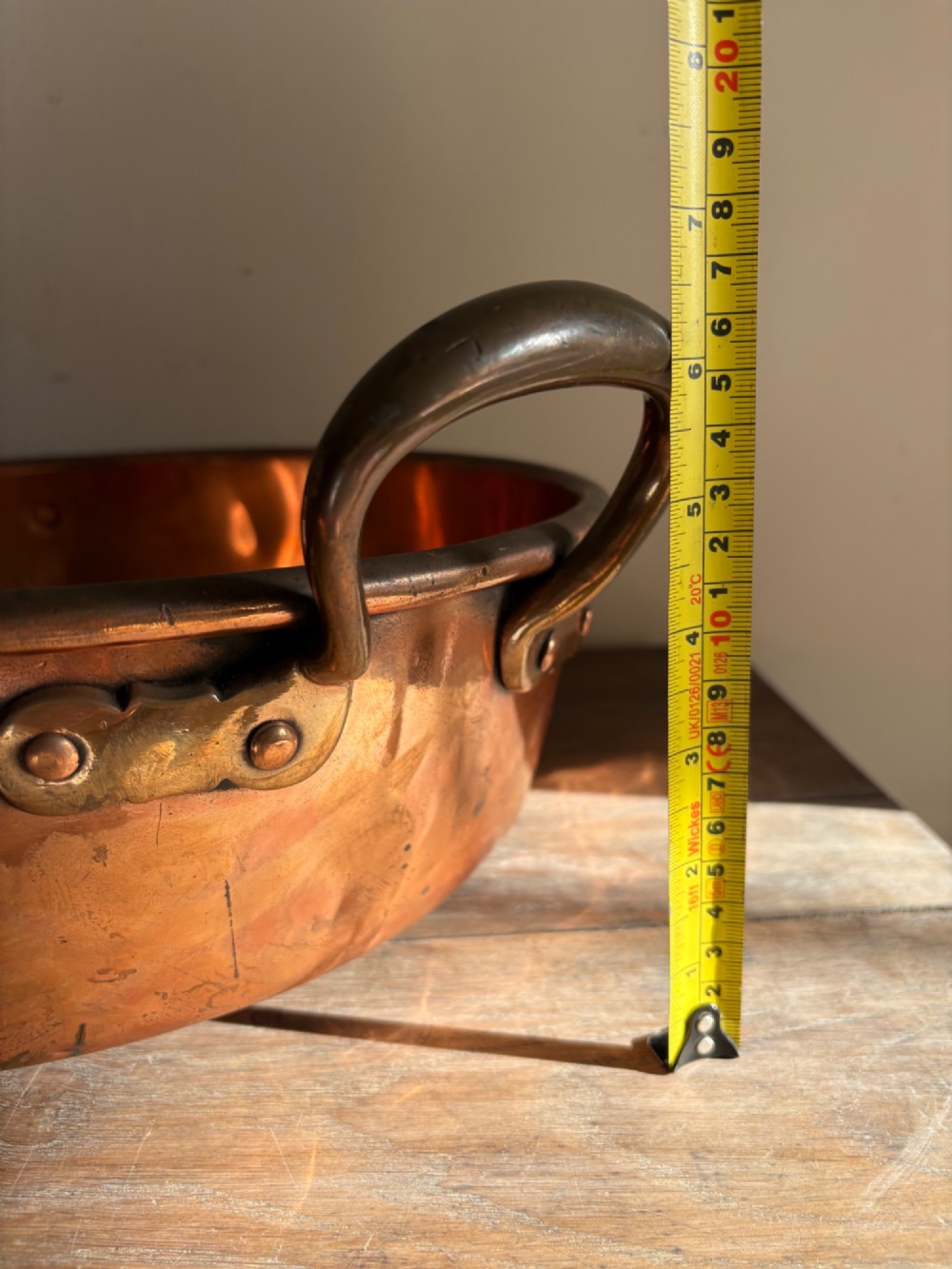 A large 19th-century polished copper preserve pan featuring twin riveted brass handles. View XIV