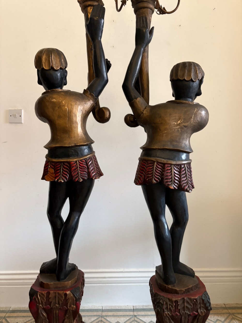 A pair of life-sized Venetian carved wood figure floor lamps featuring gilt and polychrome details, mounted on ornate pedestals with multi-light metal candelabra tops. View III