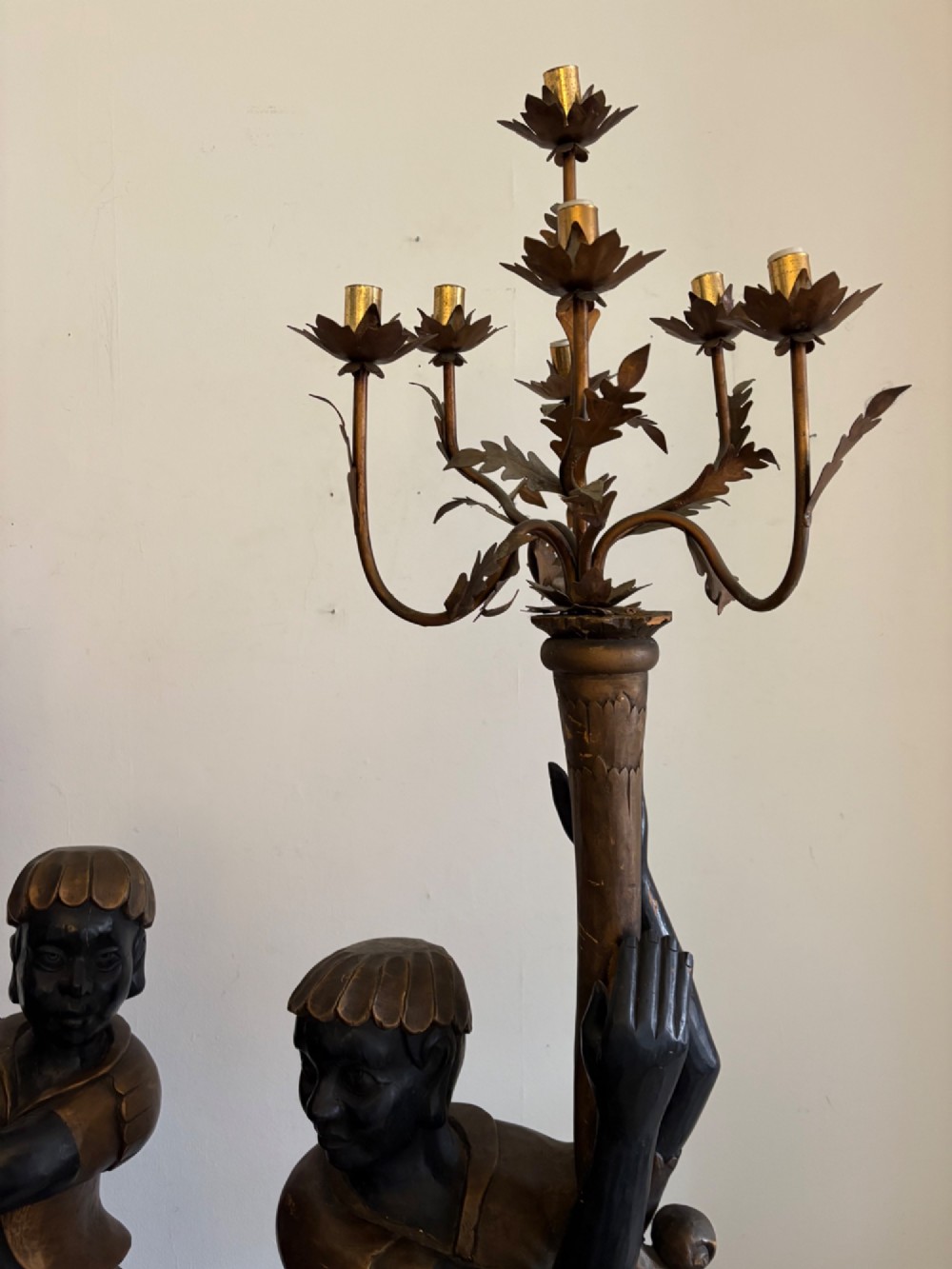 A pair of life-sized Venetian carved wood figure floor lamps featuring gilt and polychrome details, mounted on ornate pedestals with multi-light metal candelabra tops. View IX
