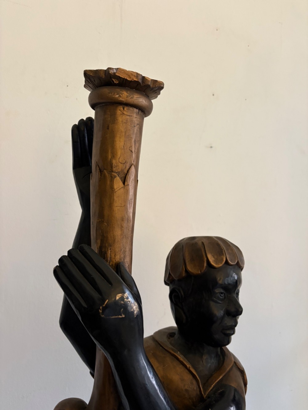 A pair of life-sized Venetian carved wood figure floor lamps featuring gilt and polychrome details, mounted on ornate pedestals with multi-light metal candelabra tops. View X