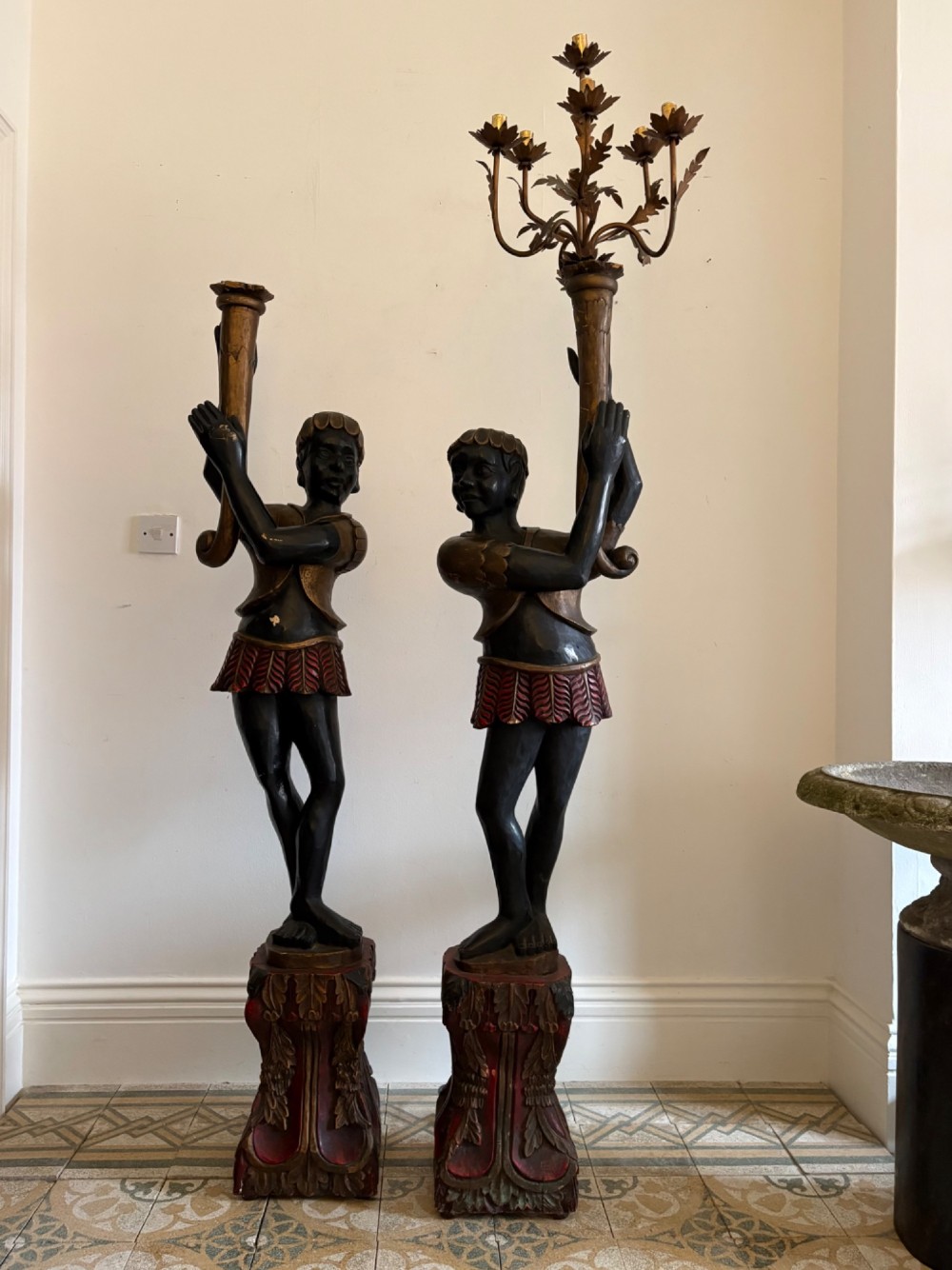 A pair of life-sized Venetian carved wood figure floor lamps featuring gilt and polychrome details, mounted on ornate pedestals with multi-light metal candelabra tops. View XI