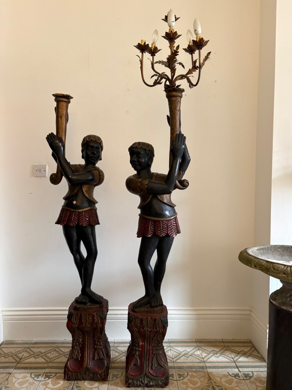 A pair of life-sized Venetian carved wood figure floor lamps featuring gilt and polychrome details, mounted on ornate pedestals with multi-light metal candelabra tops. View XIV