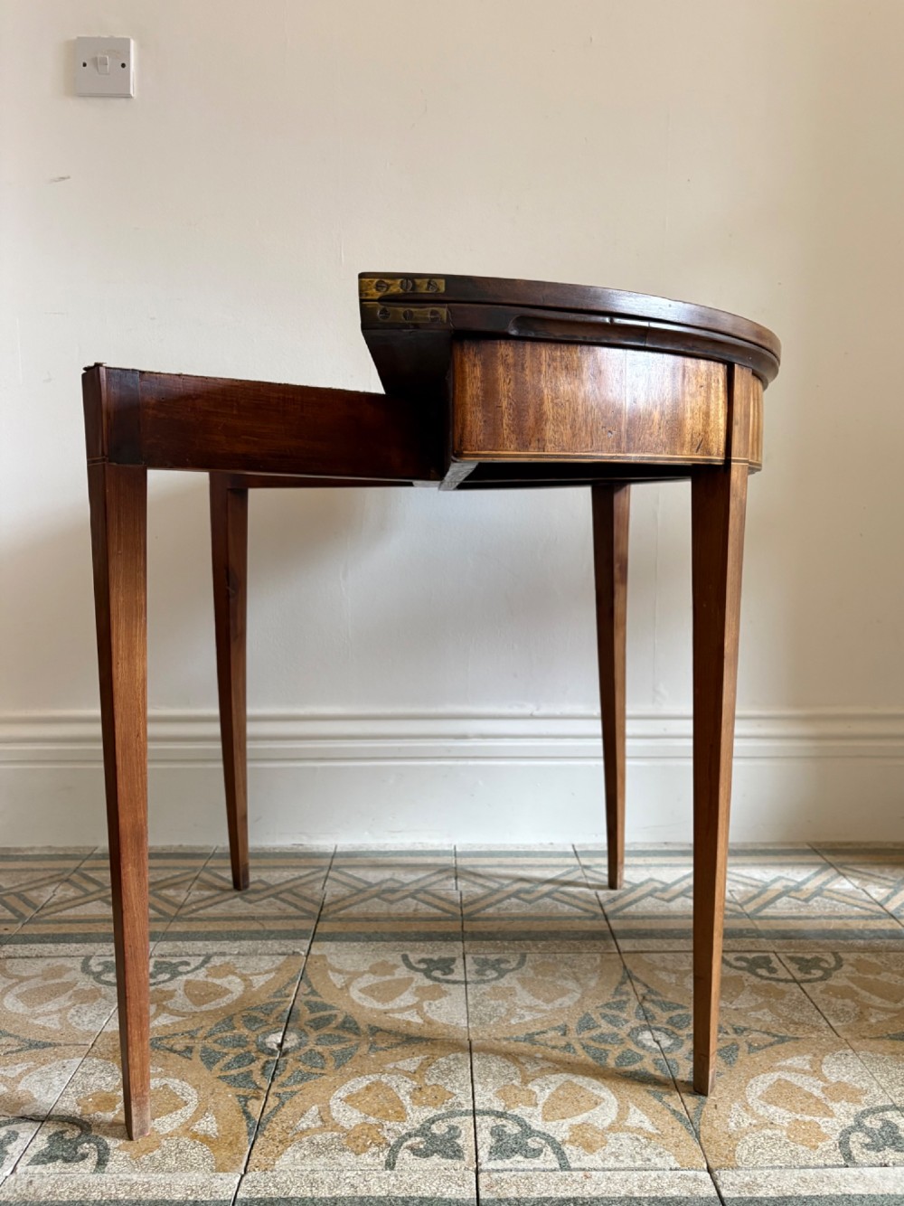 A late 18th-century George III semi-circular demi-lune folding table crafted from cherrywood and elm with four tapered square legs. View III