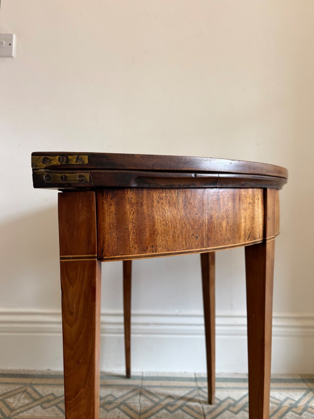 A late 18th-century George III semi-circular demi-lune folding table crafted from cherrywood and elm with four tapered square legs. View V