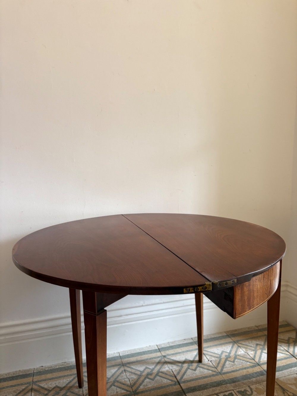 A late 18th-century George III semi-circular demi-lune folding table crafted from cherrywood and elm with four tapered square legs. View VI