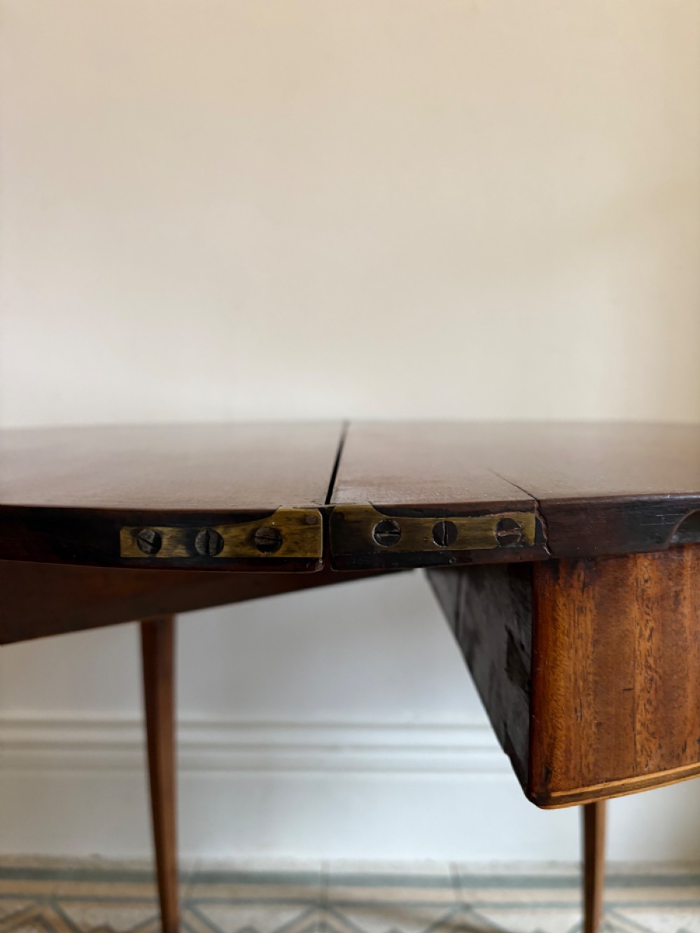 A late 18th-century George III semi-circular demi-lune folding table crafted from cherrywood and elm with four tapered square legs. View VII