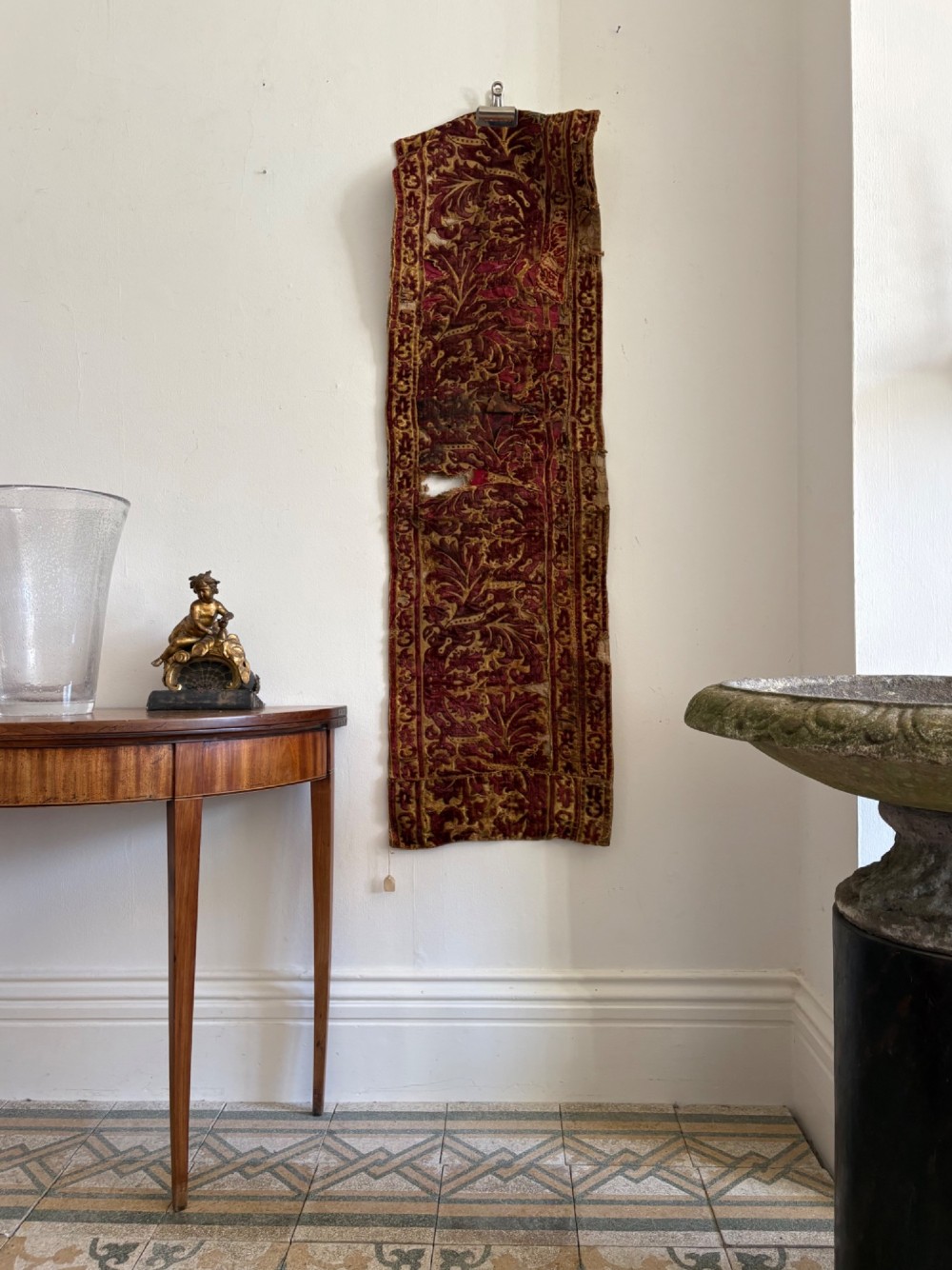 A long vertical 17th-century Italian crimson velvet textile fragment with gold silk acanthus leaf embroidery and patterned borders. View VII