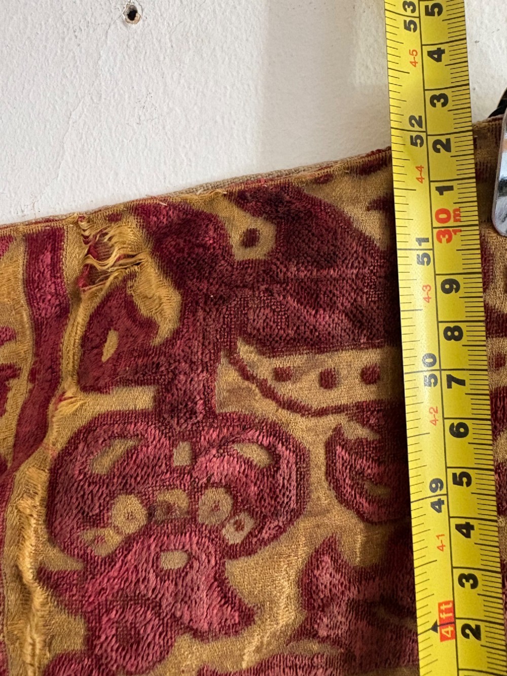 A long vertical 17th-century Italian crimson velvet textile fragment with gold silk acanthus leaf embroidery and patterned borders. View XIV