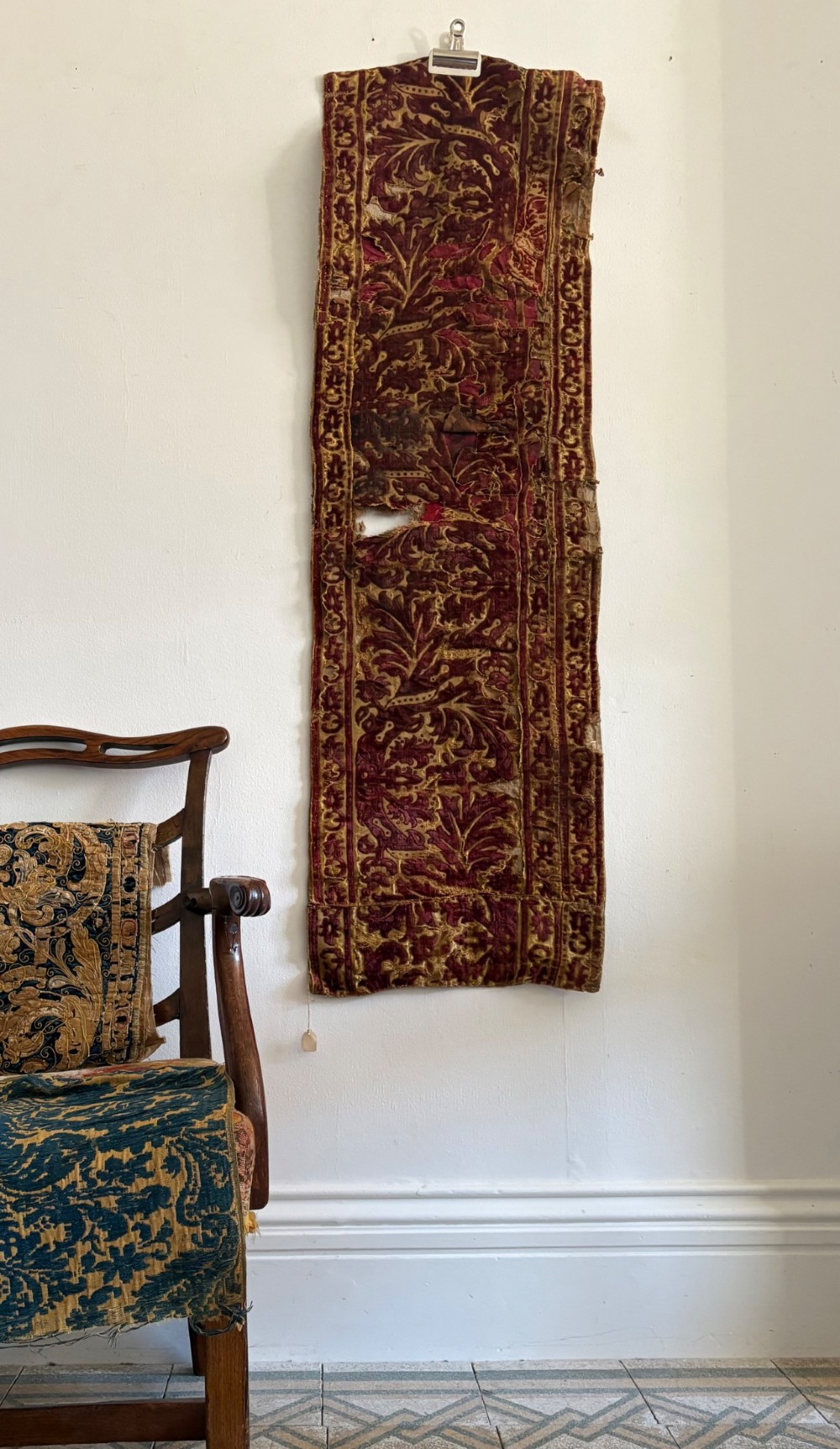 A long vertical 17th-century Italian crimson velvet textile fragment with gold silk acanthus leaf embroidery and patterned borders. View XV
