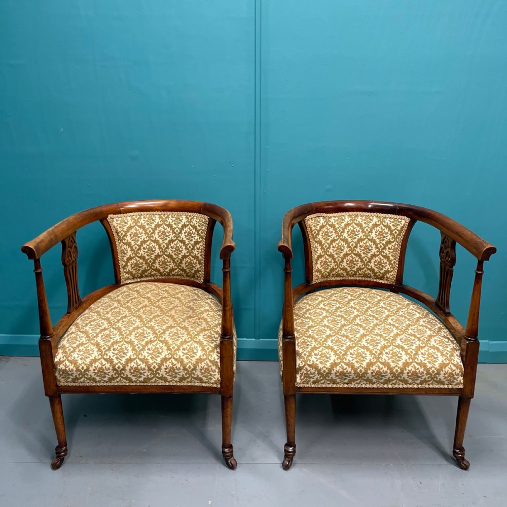 Pair of Edwardian mahogany tub armchairs on castors