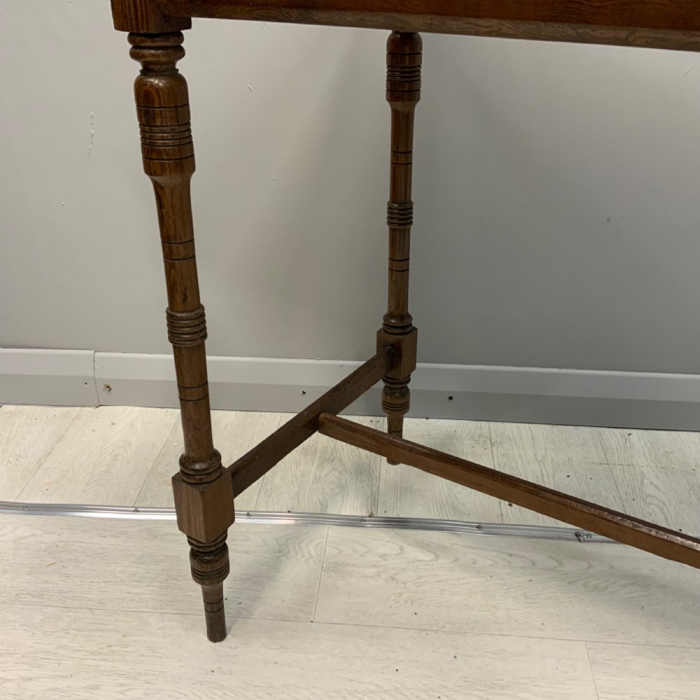 A nineteenth-century pitch pine side table featuring turned legs connected by a low stretcher base and a rectangular wooden top. View IV