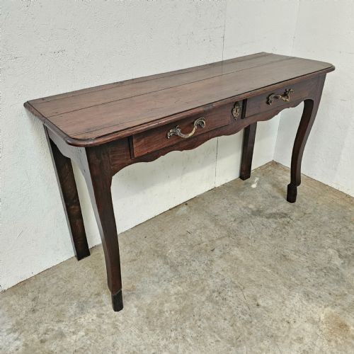 fig 1. A French cherrywood console table featuring twin front drawers with decorative brass handles, a shaped apron, and front cabriole legs.
