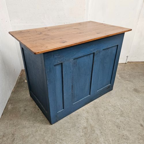 fig 1. A blue painted pine shop counter featuring three recessed front panels and an unpainted natural timber top.