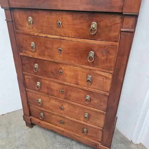 fig 1. A nineteenth-century French cherry wood semainier featuring seven drawers with brass lion mask ring handles and a grey marble top.