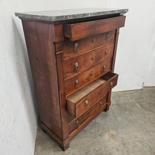 fig 2. A nineteenth-century French cherry wood semainier featuring seven drawers with brass lion mask ring handles and a grey marble top.