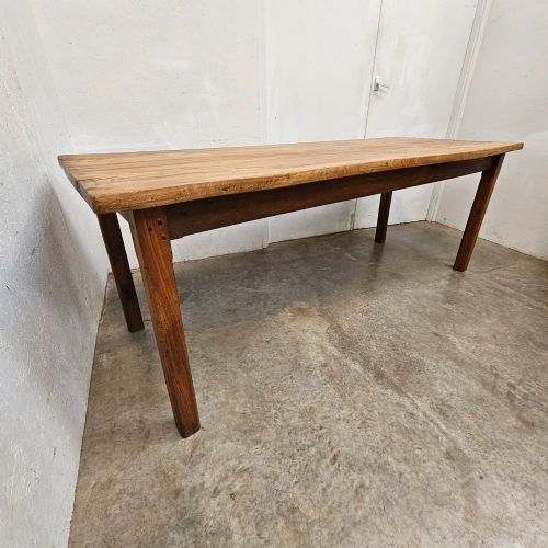 fig 2. A French rustic elm farmhouse dining table featuring a two-plank top, a pull-out side slide, and square tapered legs.