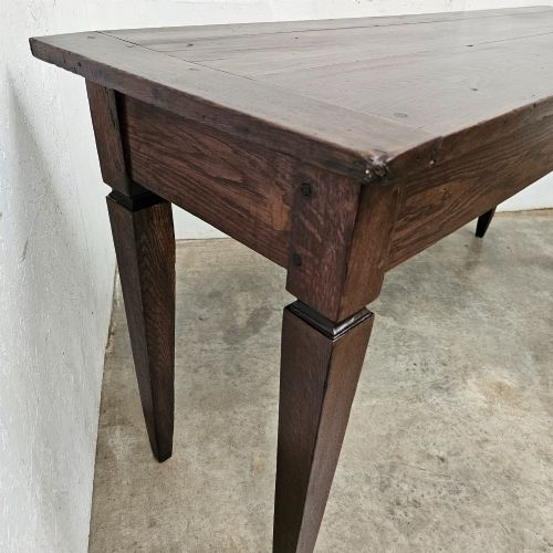 fig 1. A rectangular dark oak console table featuring four square tapered legs, a single central drawer with a wooden knob, and a flat timber top.