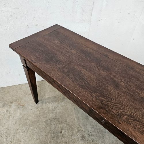 fig 2. A rectangular dark oak console table featuring four square tapered legs, a single central drawer with a wooden knob, and a flat timber top.