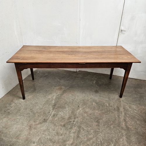 fig 1. A rectangular French cherrywood farmhouse dining table featuring a plank top, simple apron, and four tapered square legs.