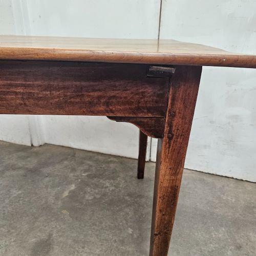 fig 2. A rectangular French cherrywood farmhouse dining table featuring a plank top, simple apron, and four tapered square legs.