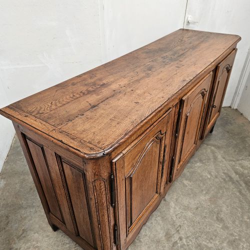 fig 1. A French provincial oak enfilade featuring three arched panel doors, external iron hinges, and a scalloped lower apron.