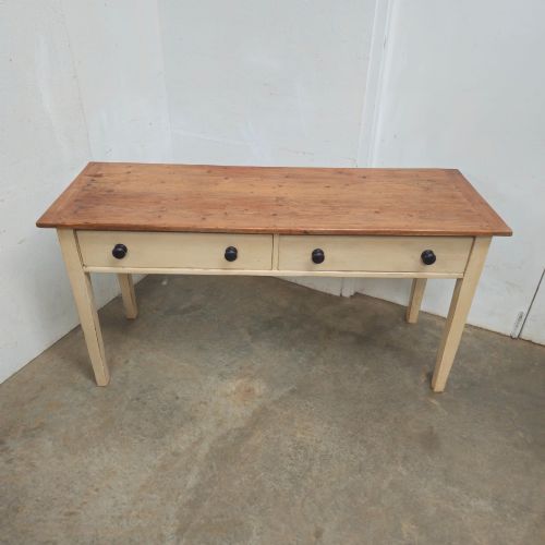 fig 2. A nineteenth-century English painted pine dairy table with a natural timber top, a cream painted base, double drawers, and dark turned wooden knobs.