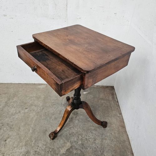 fig 1. An antique elm pedestal side table featuring a single drawer with a round wooden knob, a turned central stem, and three curved tripod legs.