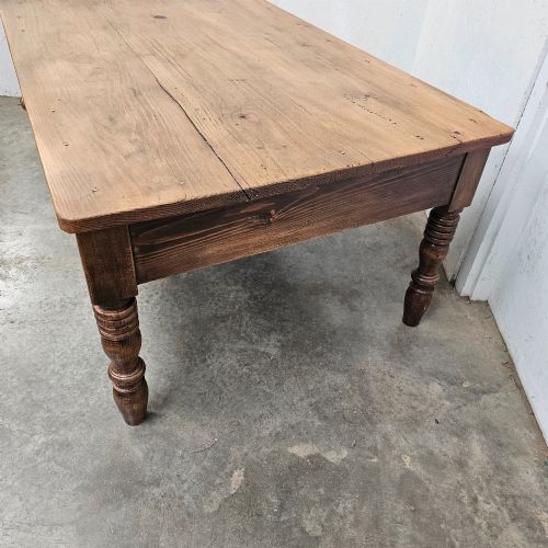 fig 1. A rectangular rustic pine coffee table featuring four turned legs and a single central frieze drawer with a round wooden knob.