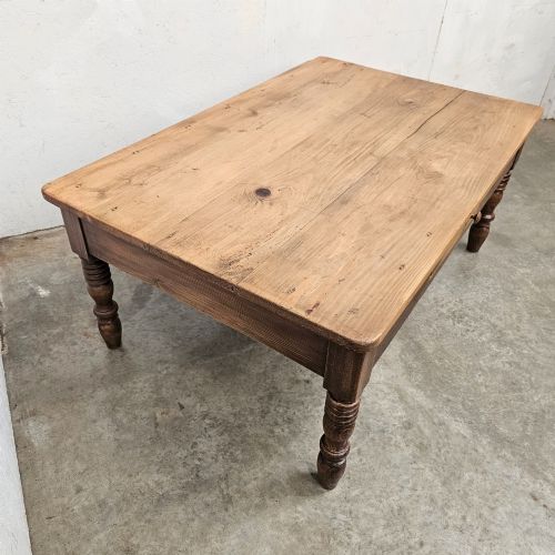 fig 2. A rectangular rustic pine coffee table featuring four turned legs and a single central frieze drawer with a round wooden knob.